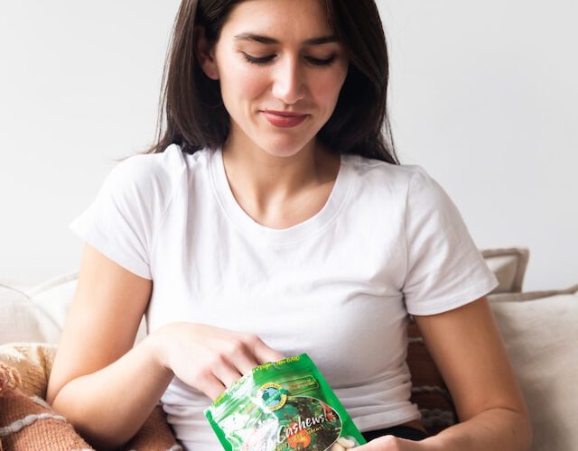 woman eating from a bag of snacks